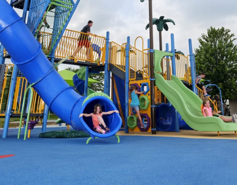 children playing on a playground with safety surfacing