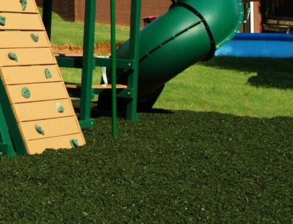 green loose rubber mulch on playground