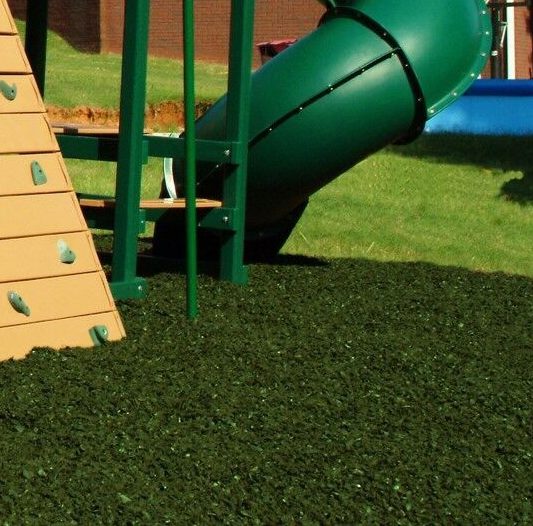 green loose rubber mulch on playground