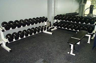 barbell racks in gym with safety tiles
