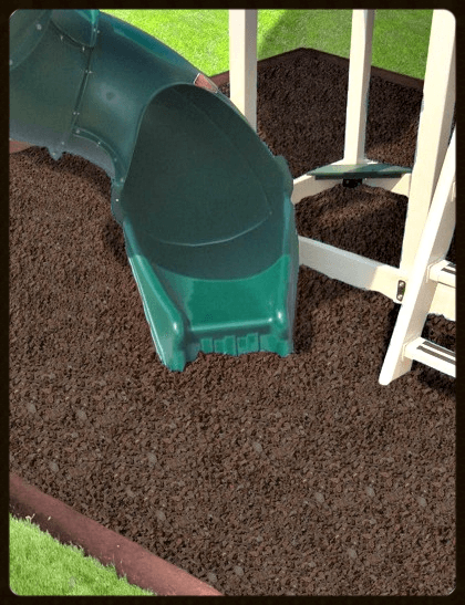 green slide leads to brown rubber mulch